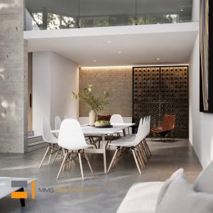 Comedor moderno de doble altura con mesa blanca, sillas, muro de ladrillo, cava de vinos iluminada y concreto aparente. Diseño por MMS Arquitectos en Estado de México y Ciudad de México