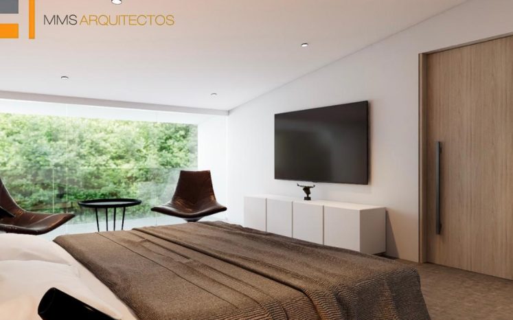 Recámara minimalista con cama, sillones, ventanal al jardín y puerta de madera. Diseño interior por MMS Arquitectos en Estado de México y Ciudad de México
